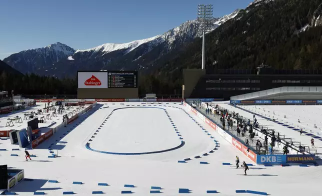 Athletes compete during a Biathlon World Cup event at the Anterselva Biathlon Arena, where the biathlon discipline will take place during the Milan Cortina 2026 Winter Olympics, in northern Italy, Saturday, Jan. 25, 2025. (AP Photo/Alessandro Trovati)