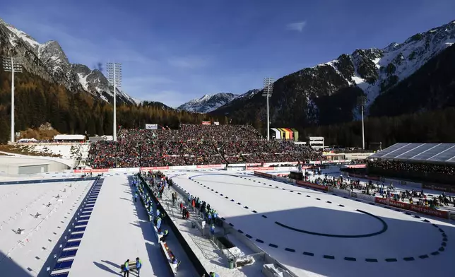 Athletes compete during a Biathlon World Cup event at the Anterselva Biathlon Arena, where the biathlon discipline will take place during the Milan Cortina 2026 Winter Olympics, in northern Italy, Saturday, Jan. 25, 2025. (AP Photo/Alessandro Trovati)