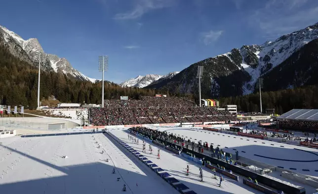 Athletes compete during a Biathlon World Cup event at the Anterselva Biathlon Arena, venue for the biathlon discipline at the Milan Cortina 2026 Winter Olympics, in Anterselva, northern Italy, Saturday, Jan. 25, 2025. (AP Photo/Alessandro Trovati)