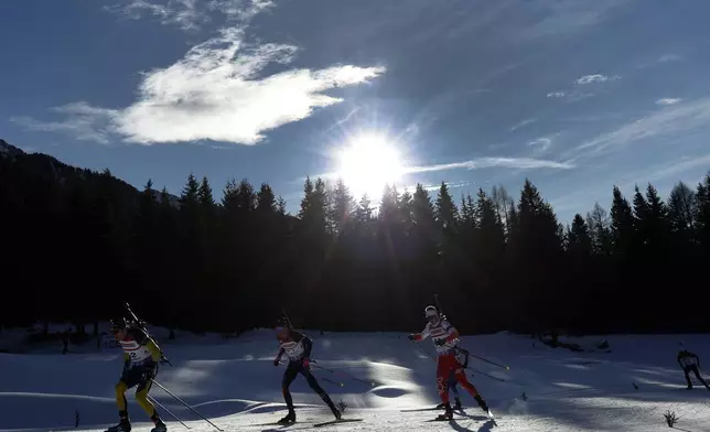 Athletes compete during a Biathlon men's World Cup 10km sprint race, in Anterselva, Italy, Friday Jan. 24, 2025. (AP Photo/Alessandro Trovati)