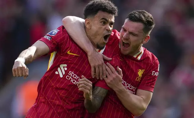 Liverpool's Luis Diaz, left, celebrates with Liverpool's Andrew Robertson after scoring his side's first goal during the English Premier League soccer match between Liverpool and Tottenham Hotspur at Anfield in Liverpool, England, Sunday, April 27, 2025. (AP Photo/Jon Super)
