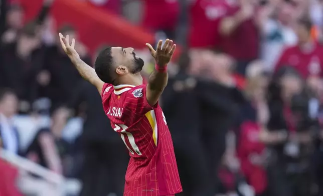 Liverpool's Mohamed Salah celebrates after winning the English Premier League soccer match between Liverpool and Tottenham Hotspur and clinching the Premier League title at Anfield in Liverpool, England, Sunday, April 27, 2025. (AP Photo/Jon Super)