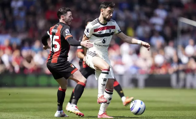Manchester United's Bruno Fernandes, right, and Bournemouth's Adam Smith battle for the ball during the English Premier League match at Vitality Stadium, Bournemouth, England, Sunday, April 27, 2025. (Adam Davy/PA via AP)