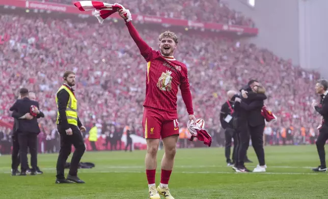 Liverpool's Harvey Elliott celebrates after winning the English Premier League soccer match between Liverpool and Tottenham Hotspur and clinching the Premier League title at Anfield in Liverpool, England, Sunday, April 27, 2025. (AP Photo/Jon Super)