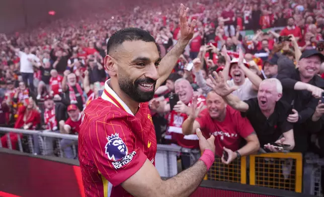 Liverpool's Mohamed Salah celebrates after winning the English Premier League soccer match between Liverpool and Tottenham Hotspur and clinching the Premier League title at Anfield in Liverpool, England, Sunday, April 27, 2025. (AP Photo/Jon Super)