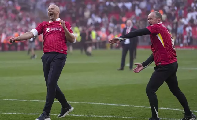 Liverpool's manager Arne Slot, left, celebrates after winning the English Premier League soccer match between Liverpool and Tottenham Hotspur and clinching the Premier League title at Anfield in Liverpool, England, Sunday, April 27, 2025. (AP Photo/Jon Super)