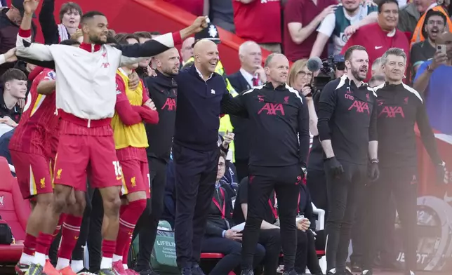 Liverpool's manager Arne Slot, center, celebrates after winning the English Premier League soccer match between Liverpool and Tottenham Hotspur and clinching the Premier League title at Anfield in Liverpool, England, Sunday, April 27, 2025. (AP Photo/Jon Super)