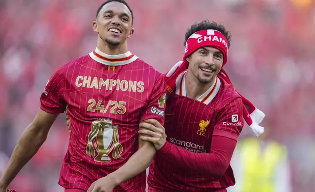 Liverpool's Trent Alexander-Arnold, left, and Curtis Jones celebrate after winning the English Premier League soccer match between Liverpool and Tottenham Hotspur and clinching the Premier League title at Anfield in Liverpool, England, Sunday, April 27, 2025. (AP Photo/Jon Super)