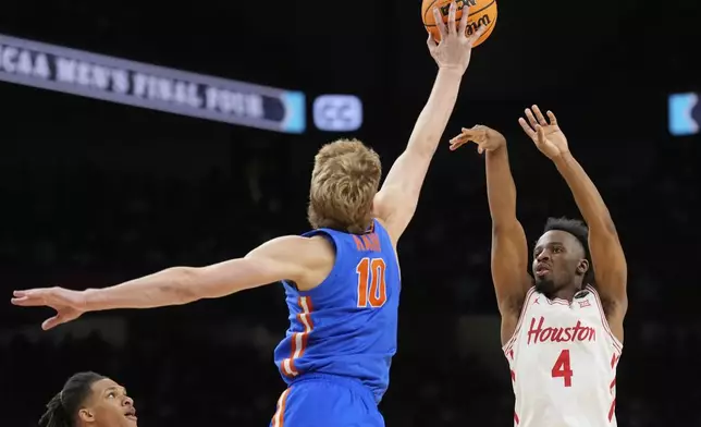 Houston's L.J. Cryer (4) has his shot blocked by Florida's Thomas Haugh (10) during the second half in the national championship at the Final Four of the NCAA college basketball tournament, Monday, April 7, 2025, in San Antonio. (AP Photo/Eric Gay)