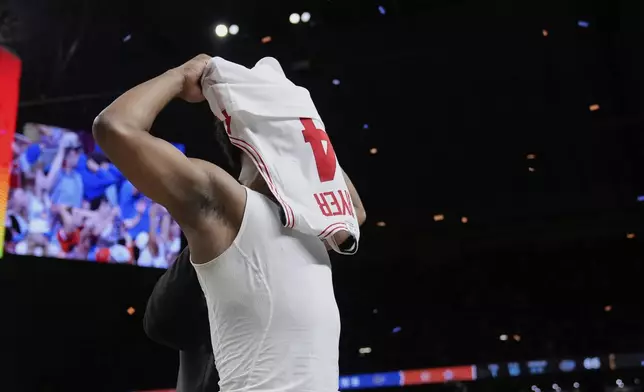 Houston's L.J. Cryer covers his face as he leaves the court after Florida beat Houston in the national championship at the Final Four of the NCAA college basketball tournament, Monday, April 7, 2025, in San Antonio. (AP Photo/Eric Gay)