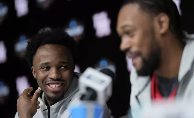 Houston guard L.J. Cryer smiles with forward J'Wan Roberts during a news conference at the Final Four of the NCAA college basketball tournament, Sunday, April 6, 2025, in San Antonio. (AP Photo/David J. Phillip)