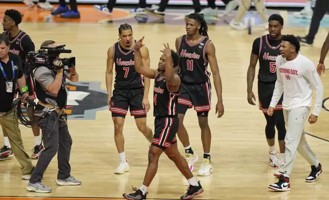Houston's L.J. Cryer (4) celebrates with teammates after Houston beat Duke in the national semifinals at the Final Four of the NCAA college basketball tournament, Saturday, April 5, 2025, in San Antonio. (AP Photo/Stephanie Scarbrough)