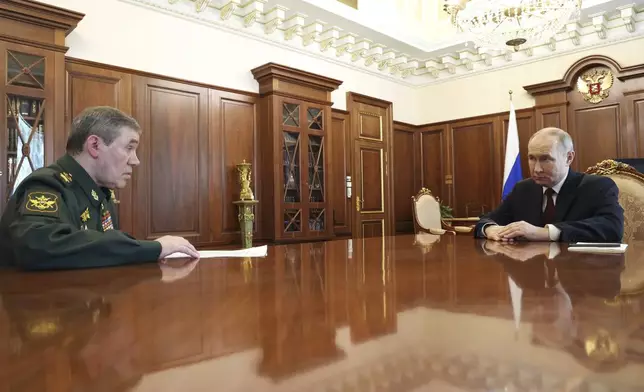 Russian President Vladimir Putin, right, speaks with Russian Chief of General Staff Gen. Valery Gerasimov during their meeting at the Kremlin in Moscow, Russia, Saturday, April 19, 2025. (Vyacheslav Prokofyev, Sputnik, Kremlin Pool Photo via AP)