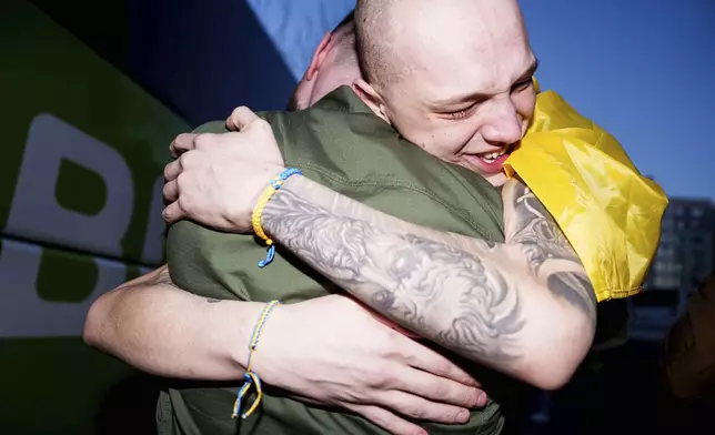 A Ukrainian soldier hugs his comrade after returning from captivity in a POW exchange in Ukraine, on Saturday, April. 19, 2025. (AP Photo/Evgeniy Maloletka)