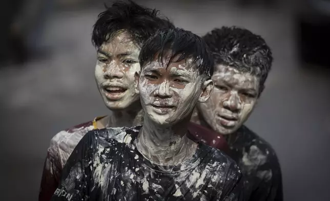 Thai people with faces stained with paint take part in the Songkran water festival to celebrate the Thai New Year in Prachinburi Province, Thailand, Sunday, April 13, 2025. (AP Photo/Wason Wanichakorn)