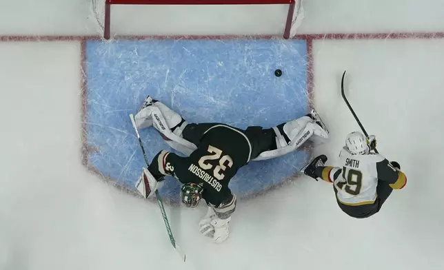 Vegas Golden Knights right wing Reilly Smith (19) scores a goal past Minnesota Wild goaltender Filip Gustavsson (32) during the third period of Game 3 of a first-round NHL hockey playoff series Thursday, April 24, 2025, in St. Paul, Minn. (AP Photo/Abbie Parr)