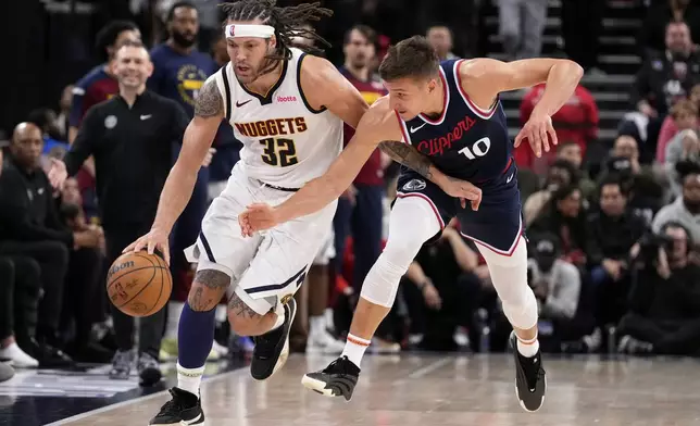 Denver Nuggets forward Aaron Gordon, drives the court while under pressure from Los Angeles Clippers guard Bogdan Bogdanovic during the second half in Game 4 of an NBA basketball first-round playoff series Saturday, April 26, 2025, in Inglewood, Calif. (AP Photo/Mark J. Terrill)