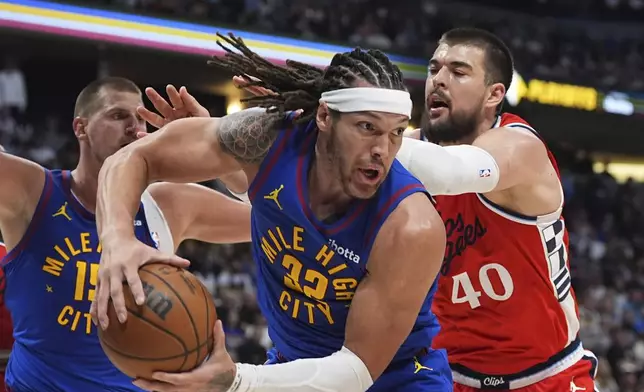 Denver Nuggets forward Aaron Gordon, front, pulls in a rebound as Los Angeles Clippers center Ivica Zubac defends in the second half of Game 1 of an NBA first-round playoff series Saturday, April 19, 2025, in Denver. (AP Photo/David Zalubowski)