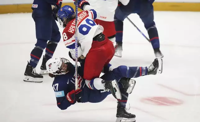 United States' Britta Curl, left, collides with Kristyna Kaltounkova of Czech Republic during the semi final match between Czech Republic and United States at the Women's Ice Hockey Championships in Ceske Budejovice, Czech Republic, Saturday, April 19, 2025. (AP Photo/Petr David Josek)