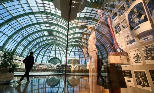 A man walks past a storefront inside Mall of the Emirates in in Dubai, United Arab Emirates, Thursday, April 17, 2025. (AP Photo/Fatima Shbair)