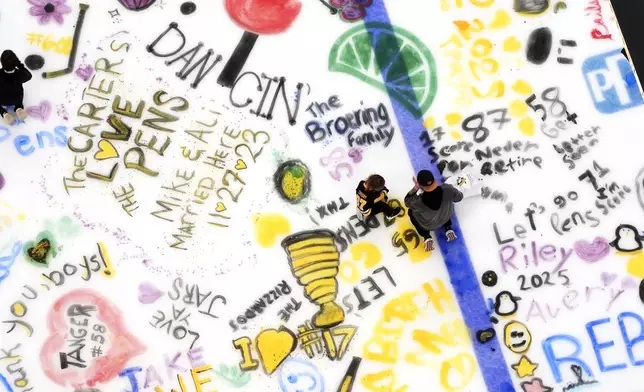 Pittsburgh Penguins season ticket holders participate in Paint The Ice day at PPG Arena, marking the end of the NHL hockey season for their Penguins, in Pittsburgh, Saturday, April 19, 2025. (AP Photo/Gene J. Puskar)