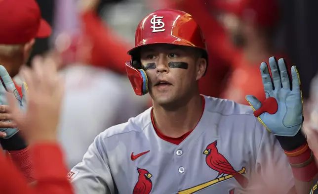 St. Louis Cardinals' Lars Nootbaar celebrates with teammates in the dugout after hitting a two-run home run in the third inning of a baseball game against the Atlanta Braves, Tuesday, April 22, 2025, in Atlanta. (AP Photo/Colin Hubbard)
