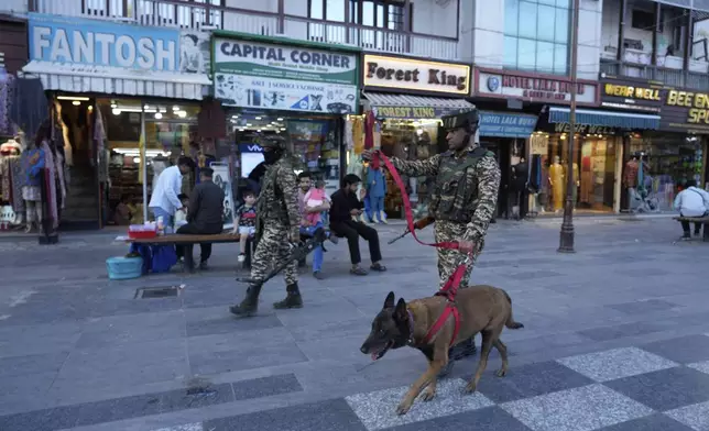 Indian paramilitary soldiers patrol as they guard at a busy market in Srinagar, Indian controlled Kashmir, Tuesday, April 29, 2025. (AP Photo/Mukhtar Khan)