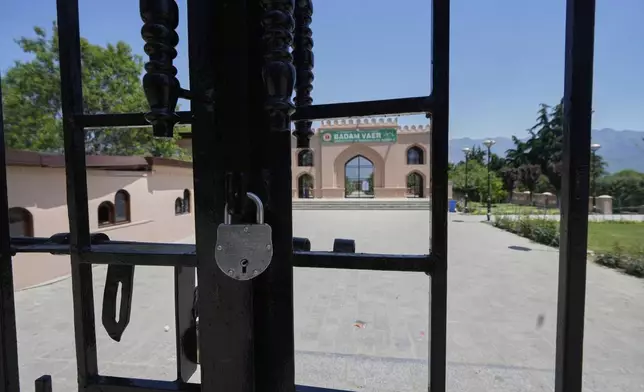 A locked garden gate is seen in Srinagar after it was closed by authorities as a precautionary safety measure following last week's deadly attack on tourists near the resort town of Pahalgam, Indian controlled Kashmir, Tuesday, April 29, 2025. (AP Photo/Mukhtar Khan)