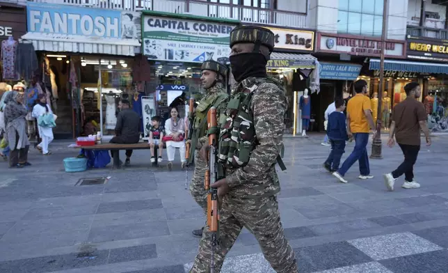 Indian paramilitary soldiers patrol as they guard at a busy market in Srinagar, Indian controlled Kashmir, Tuesday, April 29, 2025. (AP Photo/Mukhtar Khan)