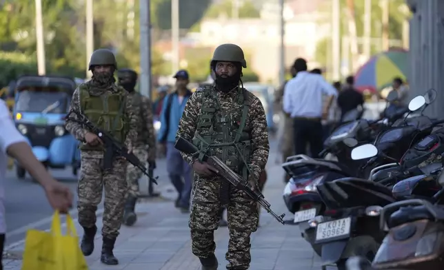 Indian paramilitary soldiers patrol as they guard at a busy market in Srinagar, Indian controlled Kashmir, Tuesday, April 29, 2025. (AP Photo/Mukhtar Khan)