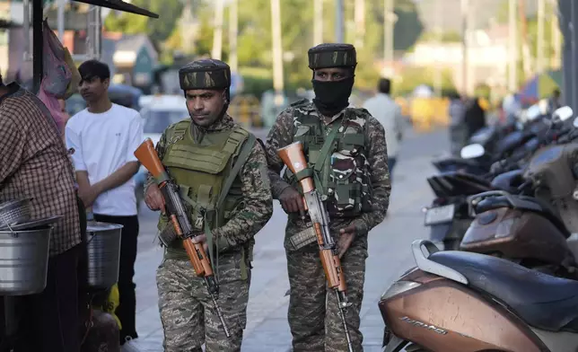 Indian paramilitary soldiers patrol as they guard at a busy market in Srinagar, Indian controlled Kashmir, Tuesday, April 29, 2025. (AP Photo/Mukhtar Khan)