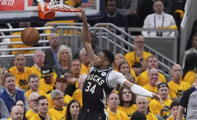 Milwaukee Bucks' Giannis Antetokounmpo (34) dunks during the second half of a first-round NBA basketball playoff game against the Indiana Pacers, Saturday, April 19, 2025, in Indianapolis. (AP Photo/Michael Conroy)