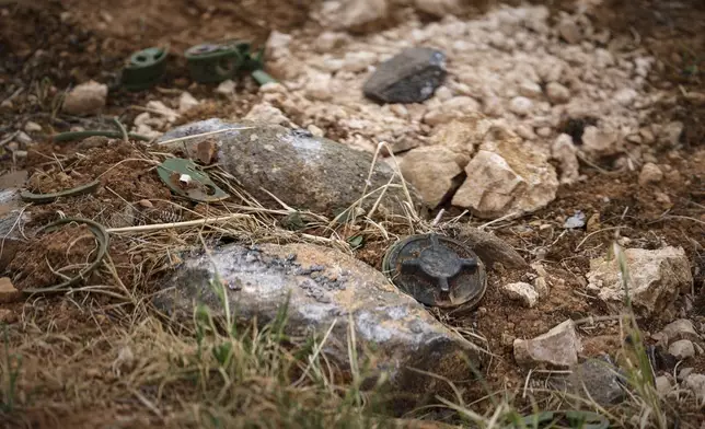 Land mines are seen in a field during a ministry of defence operation to clear and detonate explosives left by the Syrian army during the war, in agricultural land south of Idlib, Syria, Sunday, April 13, 2025. (AP Photo/Ghaith Alsayed)