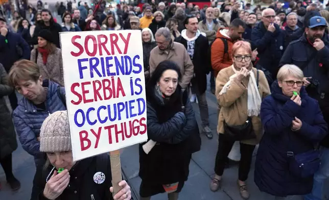 People protest the government's expulsion and entry bans on foreign citizens, for alleged security risks to the Balkan country, in Belgrade, Serbia, Thursday, April 10, 2025. (AP Photo/Darko Vojinovic)