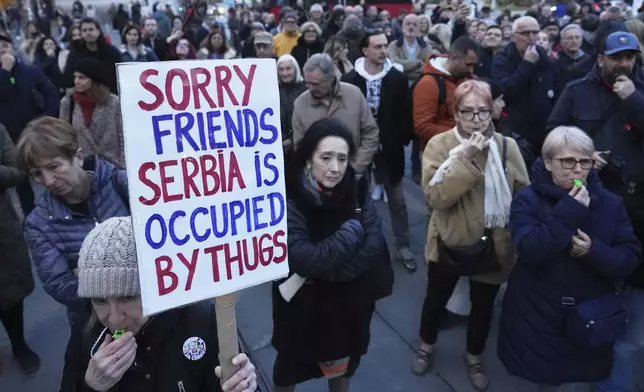 People attend a protest denouncing the expulsion and entry bans of dozens of foreign citizens recently due to alleged security risks for the Balkan country, in Belgrade, Serbia, Thursday, April 10, 2025. (AP Photo/Darko Vojinovic)