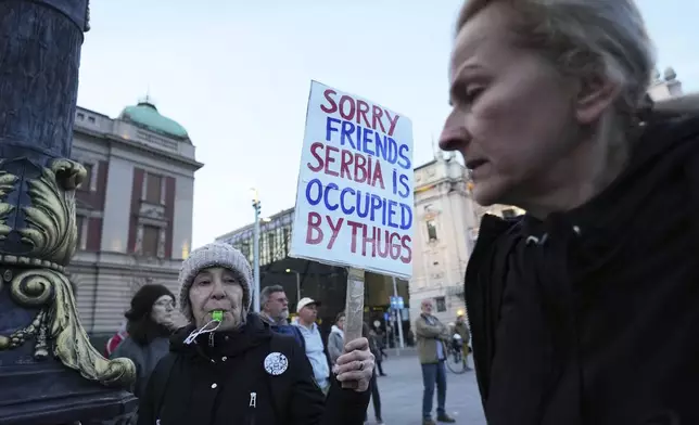 People attend a protest denouncing the expulsion and entry bans of dozens of foreign citizens recently due to alleged security risks for the Balkan country, in Belgrade, Serbia, Thursday, April 10, 2025. (AP Photo/Darko Vojinovic)