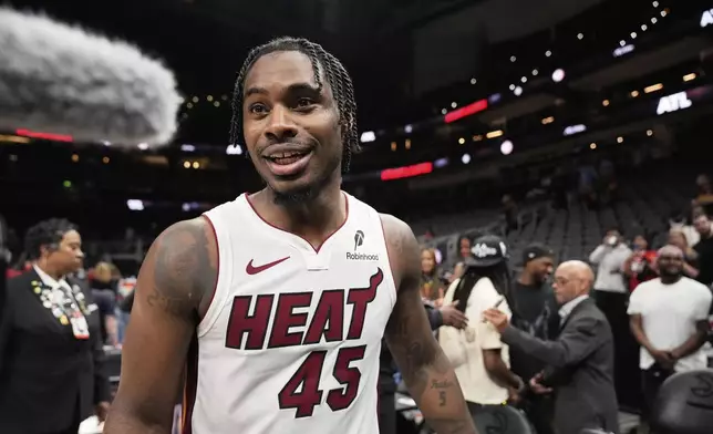 Miami Heat guard Davion Mitchell (45) leaves the court after a win against the Atlanta Hawks, after an NBA play-in tournament basketball, Friday, April 18, 2025, in Atlanta. (AP Photo/Brynn Anderson)