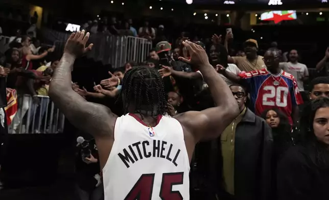 Miami Heat guard Davion Mitchell (45) leaves the court after a win against the Atlanta Hawks, after an NBA play-in tournament basketball, Friday, April 18, 2025, in Atlanta. (AP Photo/Brynn Anderson)