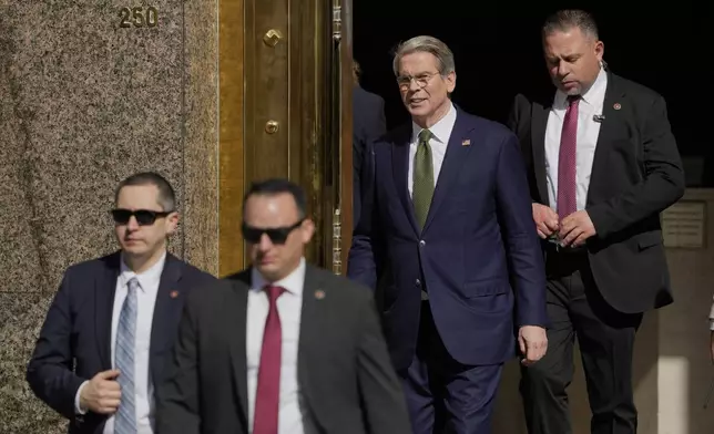 U.S Treasury Secretary Scott Bessent, second from right, leaves Argentina's Economy Ministry to head to the government house in Buenos Aires, Monday, April 14, 2025. (AP Photo/Natacha Pisarenko)