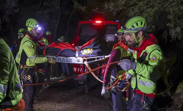 Rescuers recoup the body of one of the victims of a cable car carrying tourists south of Naples which crashed after the cable snapped, killing at least four people and injuring one in Castellamare di Stabia, near Naples, Italy, Thursday, April 17, 2025. (AP Photo/Salvatore Laporta)