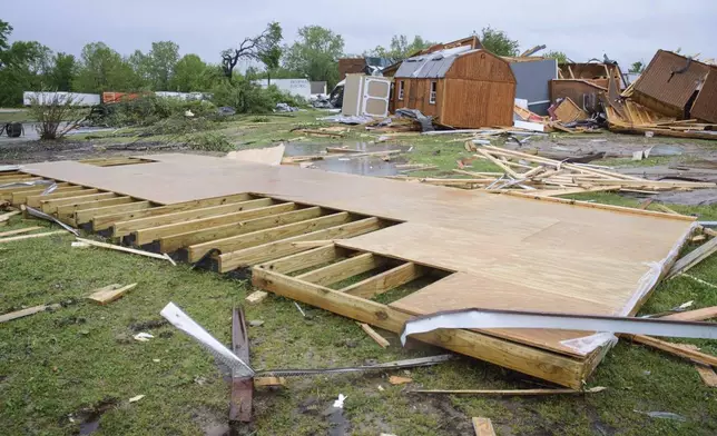 Broken sheds, lumber, and walls lie strewn on the ground behind Quality Inn, Sunday, April 20, 2025 in Ada, Okla. (Richard R. Barron/The ADA News via AP)