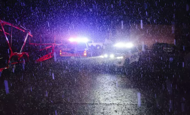 Rain falls as police vehicles block a road in Ada, Okla. Saturday, April 19, 2025. (Richard R. Barron /The ADA News via AP)