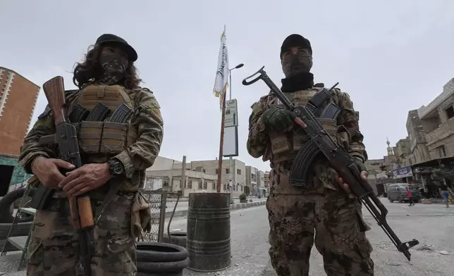 Syrian government security forces stand guard on their checkpointat one of Jaramana suburb entrances, after clashes in the area between members of the minority Druze sect and pro-government fighters, in the southern suburb of Jaramana, Damascus, Syria, Wednesday, April 30, 2025. (AP Photo/Omar Sanadiki)