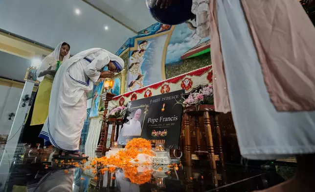 A portrait of the late Pope Francis stands in front of the altar during a requiem Mass at a church in Guwahati, India, Tuesday, April 22, 2025. (AP Photo/Anupam Nath)