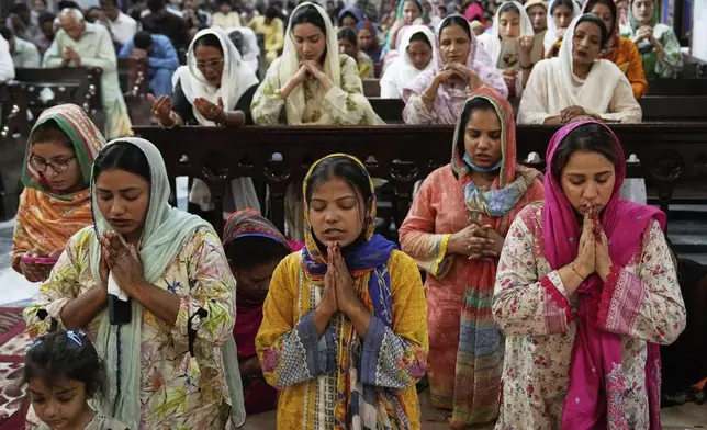 Christians attend a prayer services for late Pope Francis at the St. Anthony Church in Lahore, Pakistan, Tuesday, April 22, 2025. (AP Photo/K.M. Chaudary)