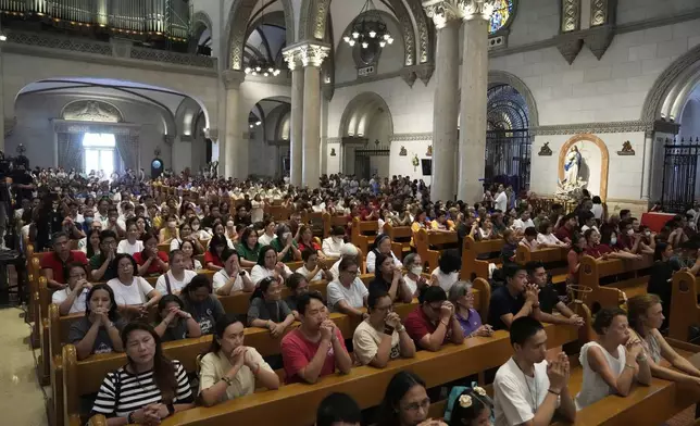 Catholics attend a mass for the late Pope Francis at the Manila Cathedral in the country's capital, Philippines Tuesday April 22, 2025. (AP Photo/Aaron Favila)