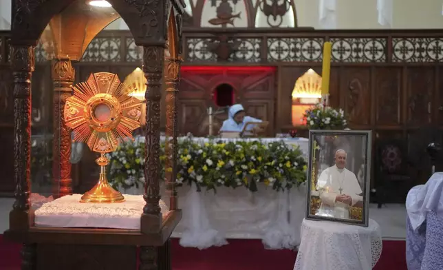 A portrait of Pope Francis is displayed in reverence at a church in Colombo, Sri Lanka, Tuesday, April 22, 2025. (AP Photo/Eranga Jayawardena)