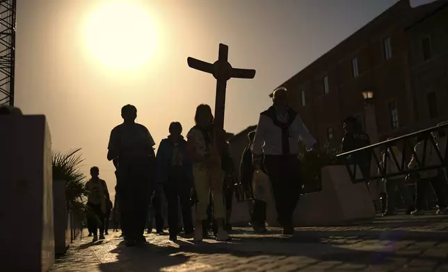 Pilgrims arrive in St. Peter's Square at the Vatican, Tuesday, April 22, 2025. (AP Photo/Francisco Seco)