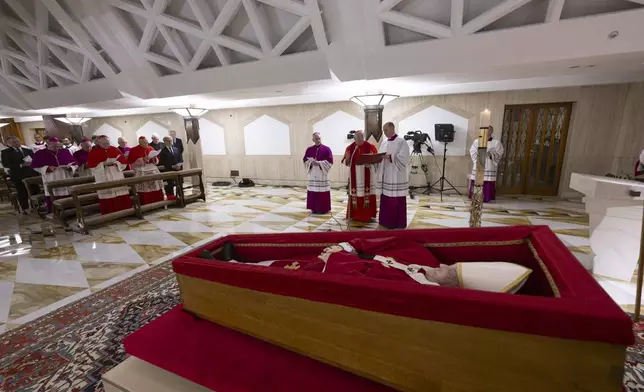 Pope Francis's body is laid out in state inside his private chapel at the Vatican, Monday, April 21, 2025. From left front row, Secretary of State Pietro Parolin, Dean Cardinal Giovanni Battista Re, unidentified person, Master of Ceremonies Archbishop Diego Giovanni Ravelli, Cardinal Camerlengo Kevin Joseph Farrell, and Master of Ceremonies Lubomir Welnitz. (Vatican Media via AP, HO)