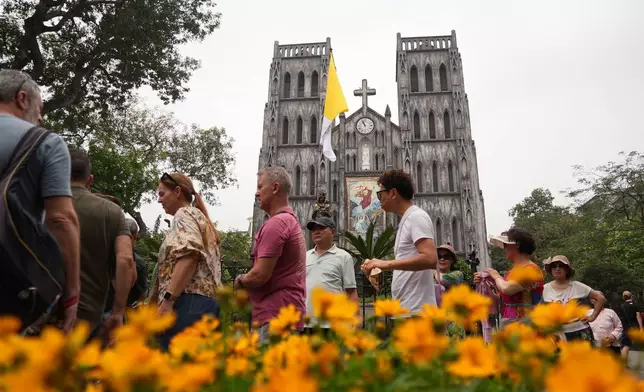 Tourists visit the St. Joseph's Cathedral in Hanoi, Vietnam, Tuesday, April 22, 2025. (AP Photo/Hau Dinh)